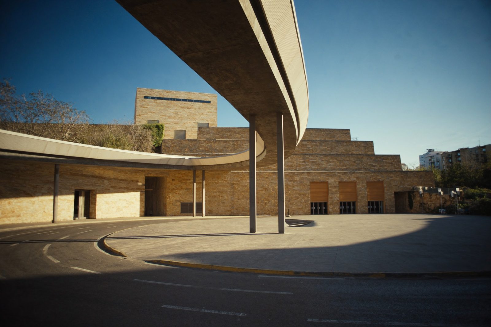 Exterior of Barcelona Sants high-speed train station under a clear blue sky